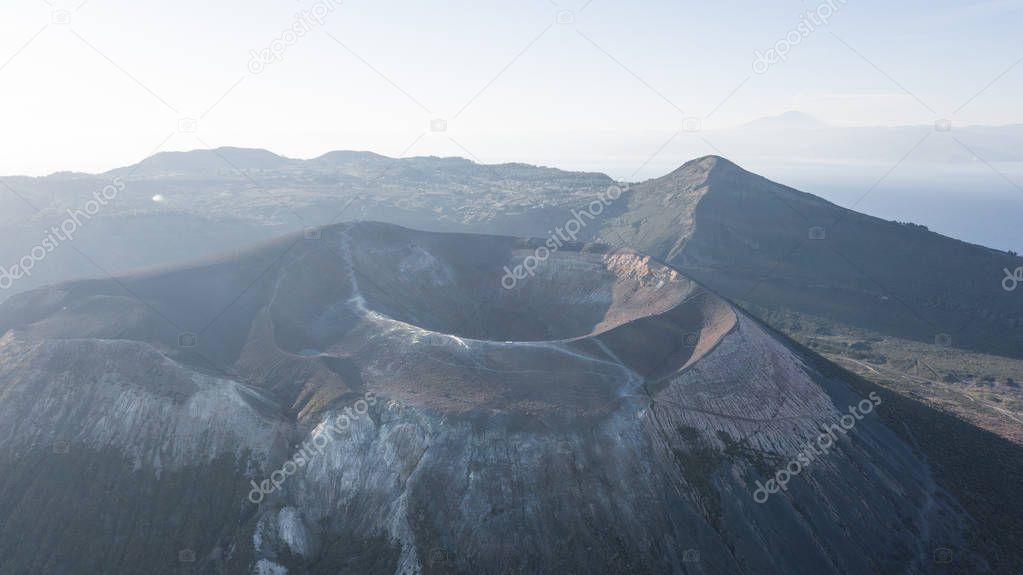 Aerial view photo from flying drone of Amazing grand Vulcano crater with fumaroles on Island at sunrise. Of Vulcano, into Lipari ,Eolie Islands. Panoramic View of crater taken Italy, Sicily