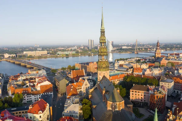 Aerial view photo from flying drone panoramic  to St. Peter\'s Church and the Old Town on the background of the Daugava River and downtown on a beautiful early morning sunrise (series)