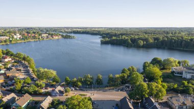 Beautiful aerial view photo from drone on Trakai city, located near Galve lake in Lithuania. Surrounded by beautiful lakes and green islands with plenty of water attractions for tourists available. (series) clipart