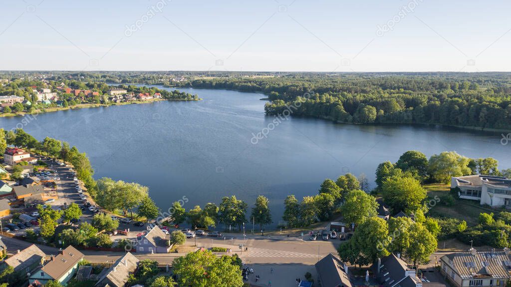 Beautiful aerial view photo from drone on Trakai city, located near Galve lake in Lithuania. Surrounded by beautiful lakes and green islands with plenty of water attractions for tourists available. (series)