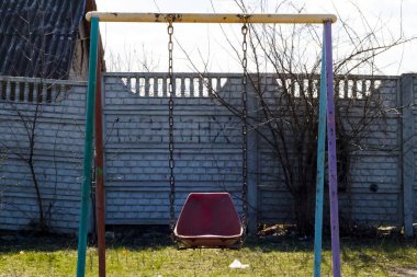 Yalnız salıncak çitin yanında duruyor