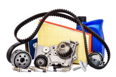 Various spare parts for the car. The set of timing belt with rollers, cooling pump, motor oil, sparking plugs and filters on a white background. clipart
