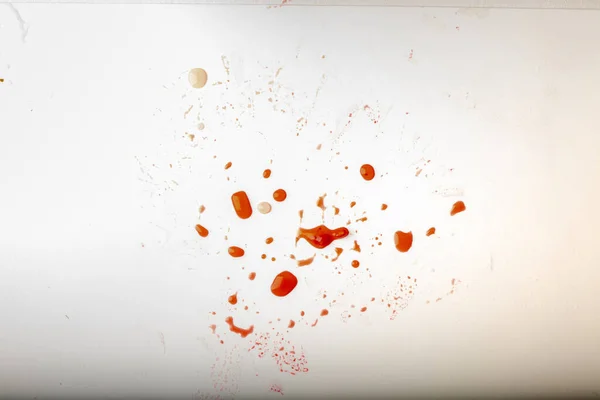 Glossy red liquid droplets, splatters isolated. drops of red juice on white dirty background