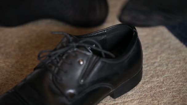 Man wears leather shoes. feet close-up — Stock Video