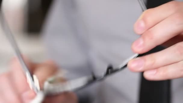 Man wipes glasses. hands closeup — Stock Video