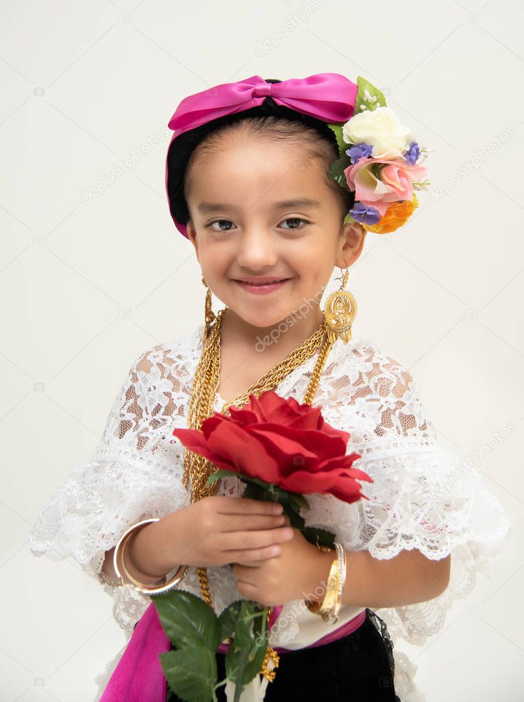 Little Mexican dancer girl dressed in a traditional folk costume of the state of Veracruz Mexico