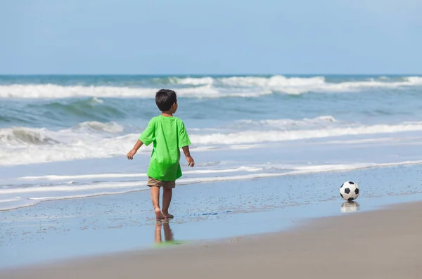 Chłopiec dziecko gra piłka nożna na plaży — Zdjęcie stockowe