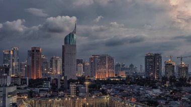 Sunset over Jakarta city downtown  clipart