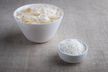 Hindistan cevizi cipsleri ve bez bir masa örtüsünün üzerindeki bir kasede talaş.