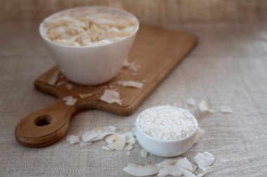 Kumaş bir masa örtüsü üzerinde bir kasede hindistan cevizi cipsi ve talaş.