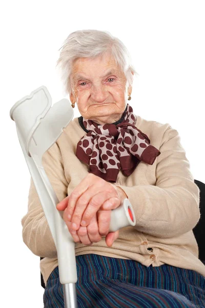 Elderly woman holding her crutch — Stock Photo, Image