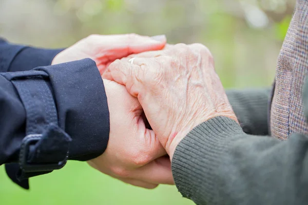 Senior & young woman holding hands Royalty Free Stock Images