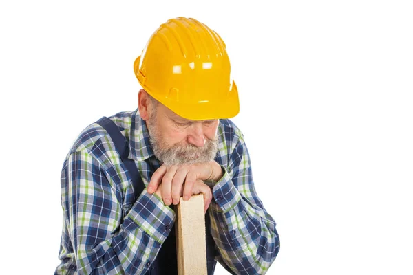 Tired male engineer holding a lath - isolated background Stock Photo