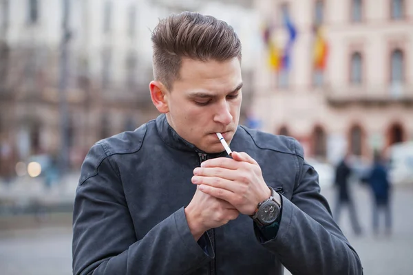 Handsome guy smoking outdoor — Stock Photo, Image