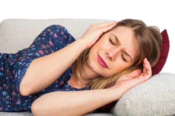 Woman on the couch having a headache — Stock Photo, Image