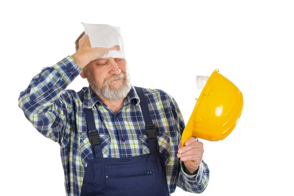 Elderly builder holding utensils — Stock Photo, Image