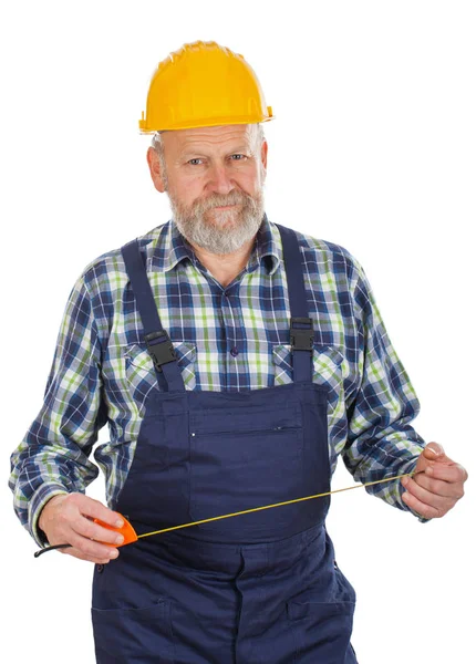 Elderly builder holding utensils — Stock Photo, Image