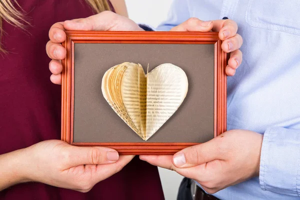 Handmade love book on picture frame — Stock Photo, Image