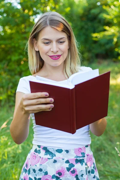 Beautiful female student holding a book — Stock Photo, Image