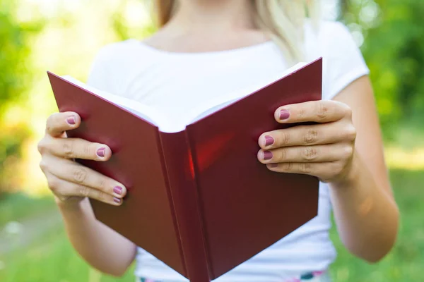 Close up female hands holding a book — Stock Photo, Image
