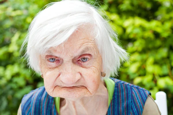 Aged woman in the garden — Stock Photo, Image