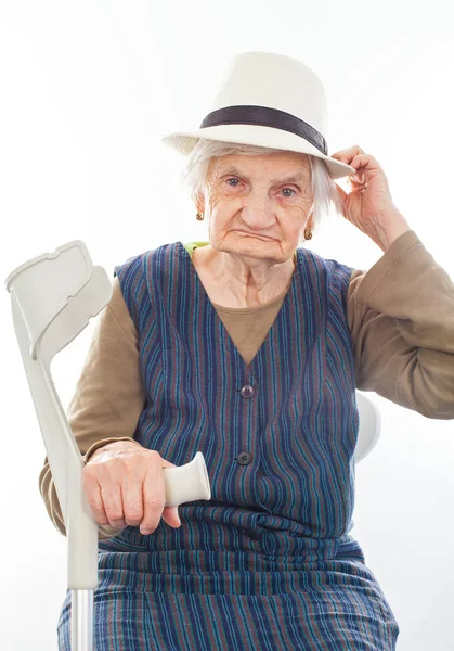 Disabled senior woman with crutch indoors — Stock Photo, Image