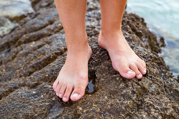 Female barefoot on a pebble beach, Croatia — Stock Photo, Image