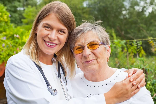 Elderly woman with female doctor — Stock Photo, Image