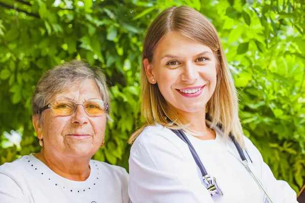 Elderly woman with female doctor — Stock Photo, Image