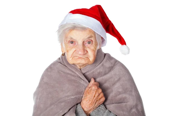 Elderly female with Santa Claus cap and blanket — Stock Photo, Image