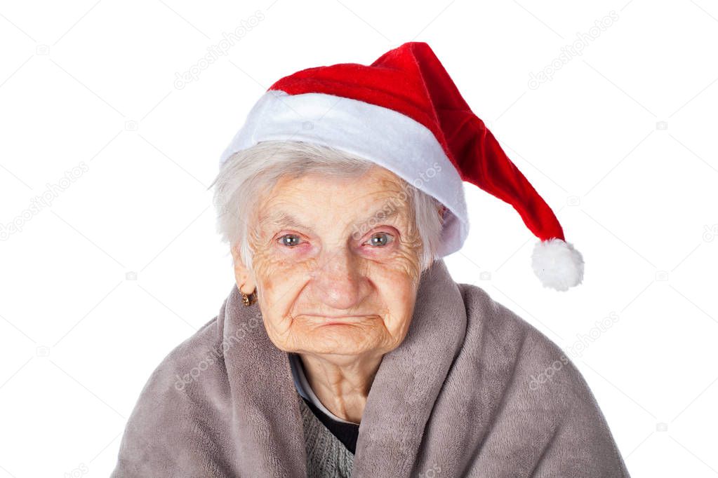 Elderly female with Santa Claus cap and blanket