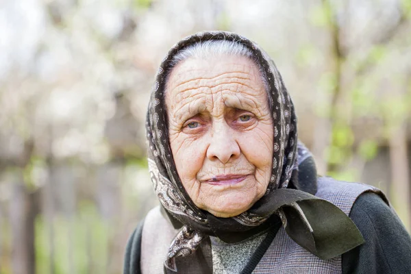 Worried old lady with headscarf — Stock Photo, Image