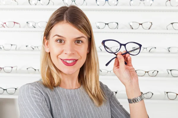 Woman choosing eyeglass frame