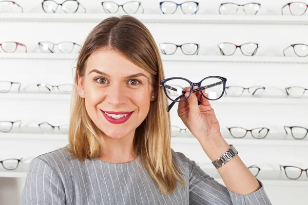 Woman choosing eyeglass frame