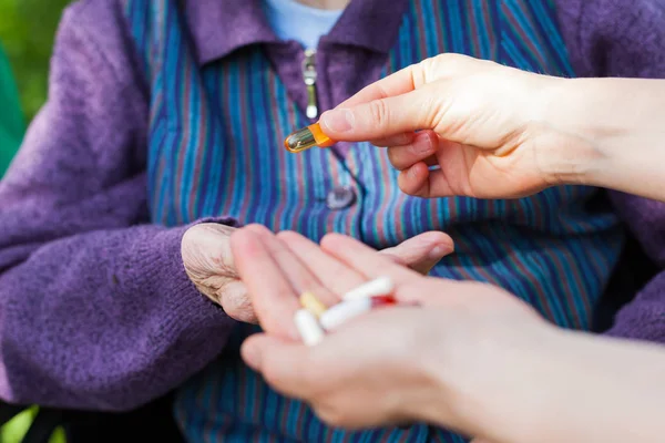 Close Picture Elderly Disabled Woman Hands Receiving Medical Drugs Caregiver — Stock Photo, Image