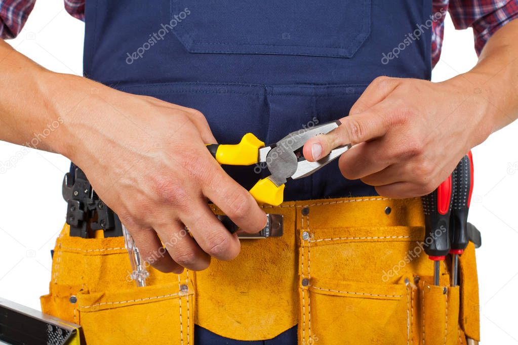 Close up picture of handyman's yellow tool belt - holding pliers on isolated background