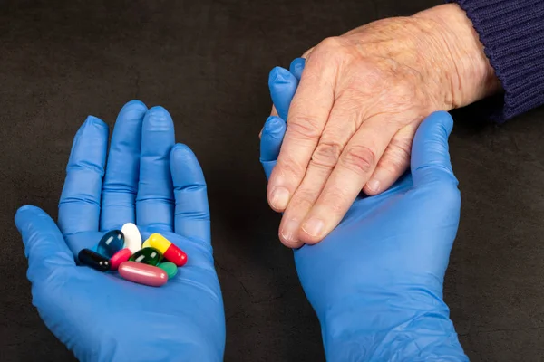 Elderly woman holding medical drugs — Stock Photo, Image