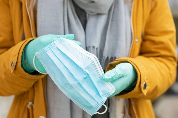 Close Picture Woman Holding Protective Mask Wearing Gloves Because Coronavirus — Stock Photo, Image