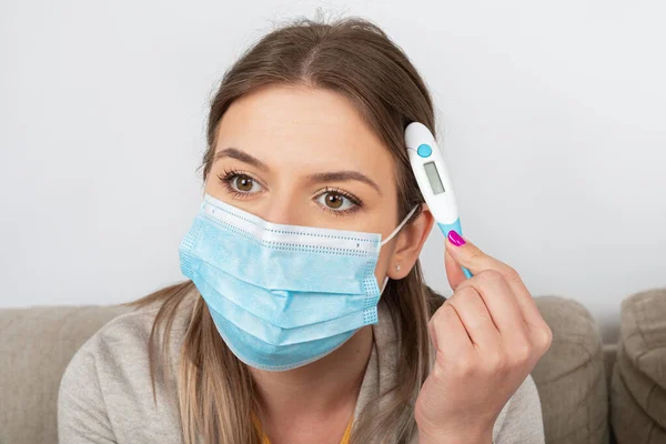 Young Woman Coronavirus Symptoms Home Wearing Mask Holding Thermometer Self — Stock Photo, Image