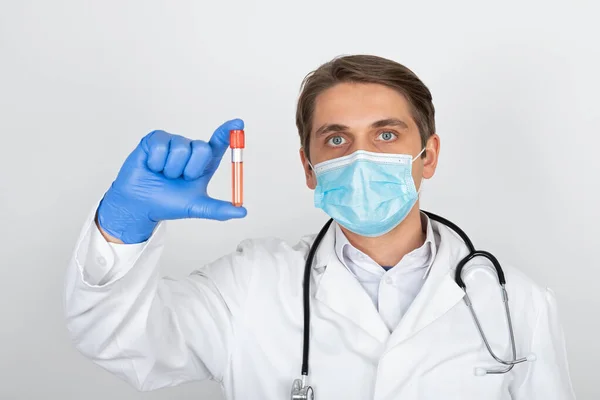 Médico Varón Joven Con Máscara Quirúrgica Guantes Sosteniendo Una Muestra —  Fotos de Stock