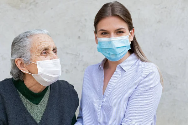 Portrait Friendly Caregiver Posing Elderly Ill Woman Wearing Surgical Mask — Stock Photo, Image