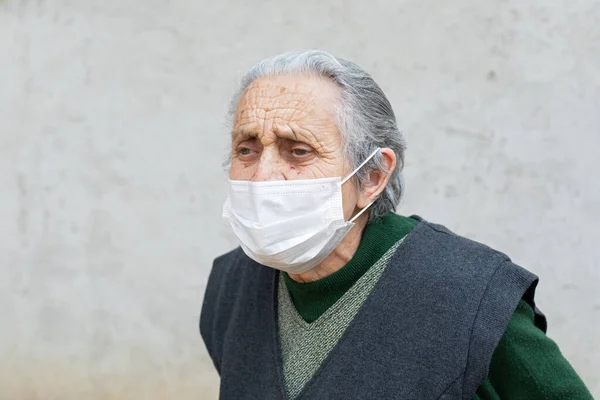 Portrait of elderly woman with chronic disease wearing protective mask because of covid-19 pandemic