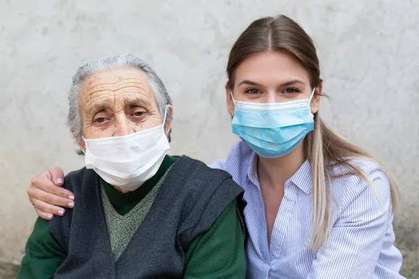 Portrait Friendly Caregiver Posing Elderly Ill Woman Wearing Surgical Mask — Stock Photo, Image