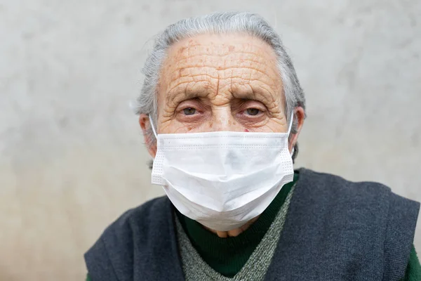 Portrait of elderly woman with chronic disease wearing protective mask because of covid-19 pandemic