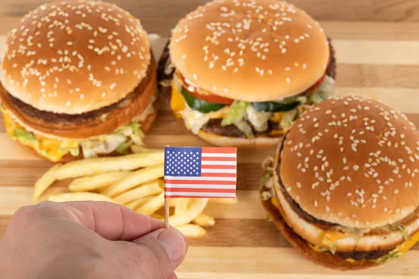 Delicious Burgers Potato Fries Wooden Table Human Hand Holding American — Stock Photo, Image