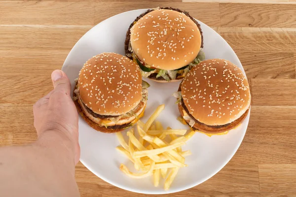 Tasty Cheeseburger Vegetables Sauce Sesame Bun French Fries Wooden Table — Stock Photo, Image