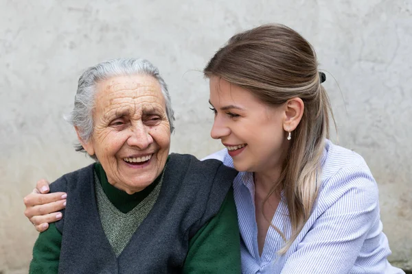 Young Friendly Woman Embracing Senior Lady Outdoor Quality Time Spent — Stock Photo, Image