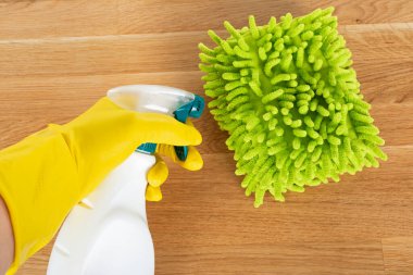 Ahşap arka planda renkli temizlik malzemeleri ve araçlarının resmi