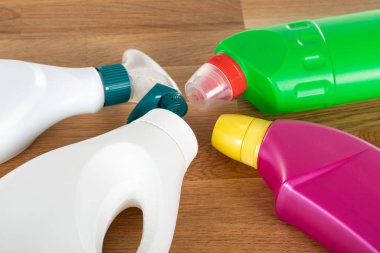 Ahşap arka planda renkli temizlik malzemeleri ve araçlarının resmi