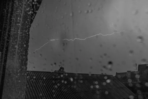 Lightning strike captured through the window in the evening — Stock Photo, Image